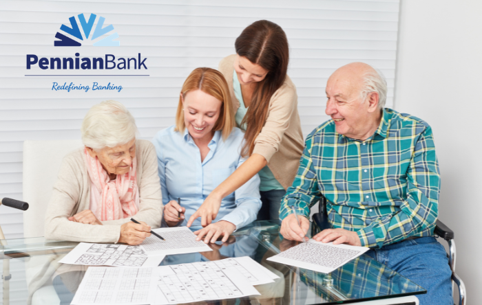 People helping an elderly couple with finances